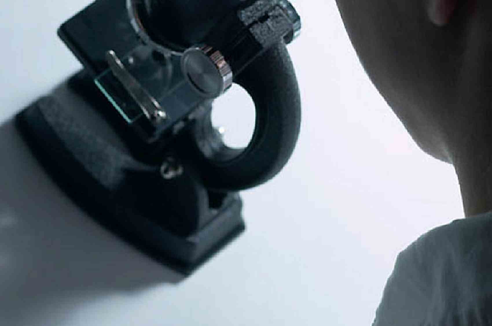 Profile of woman using black microscope.jpg